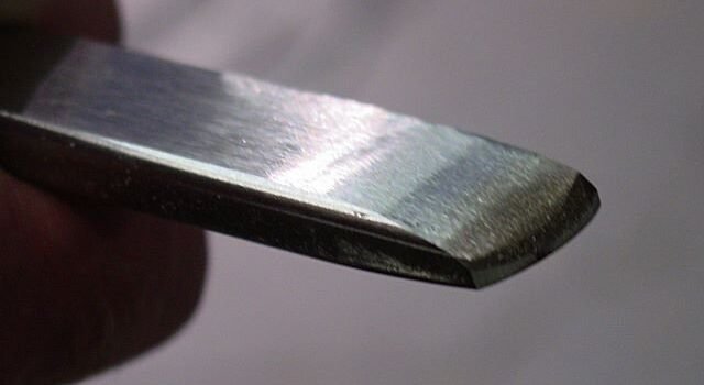 Close-up of bottom of scraper with double bevel